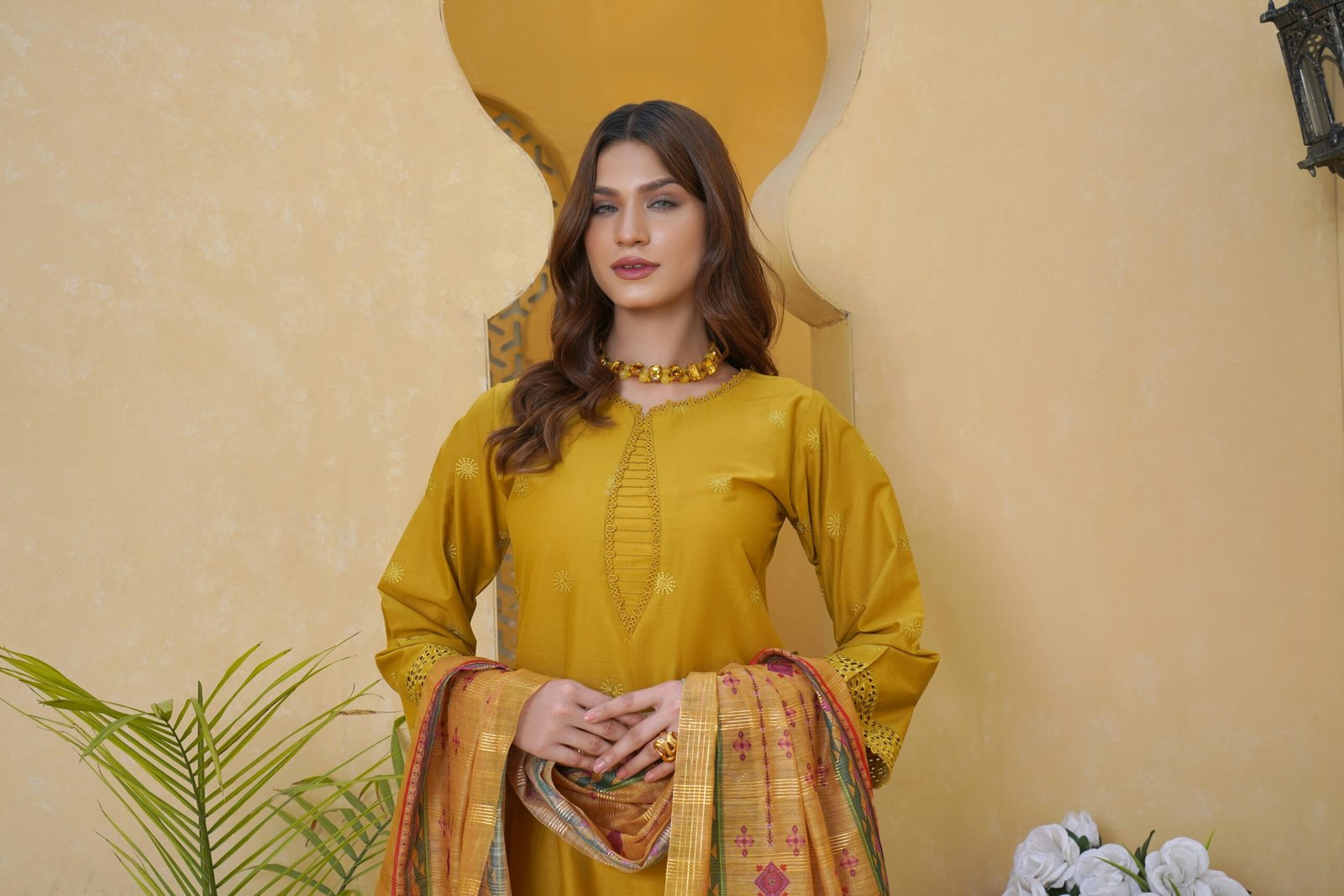 Home Fashion portrait of a woman in traditional Punjabi attire, showcasing a beautiful yellow tunic and scarf.