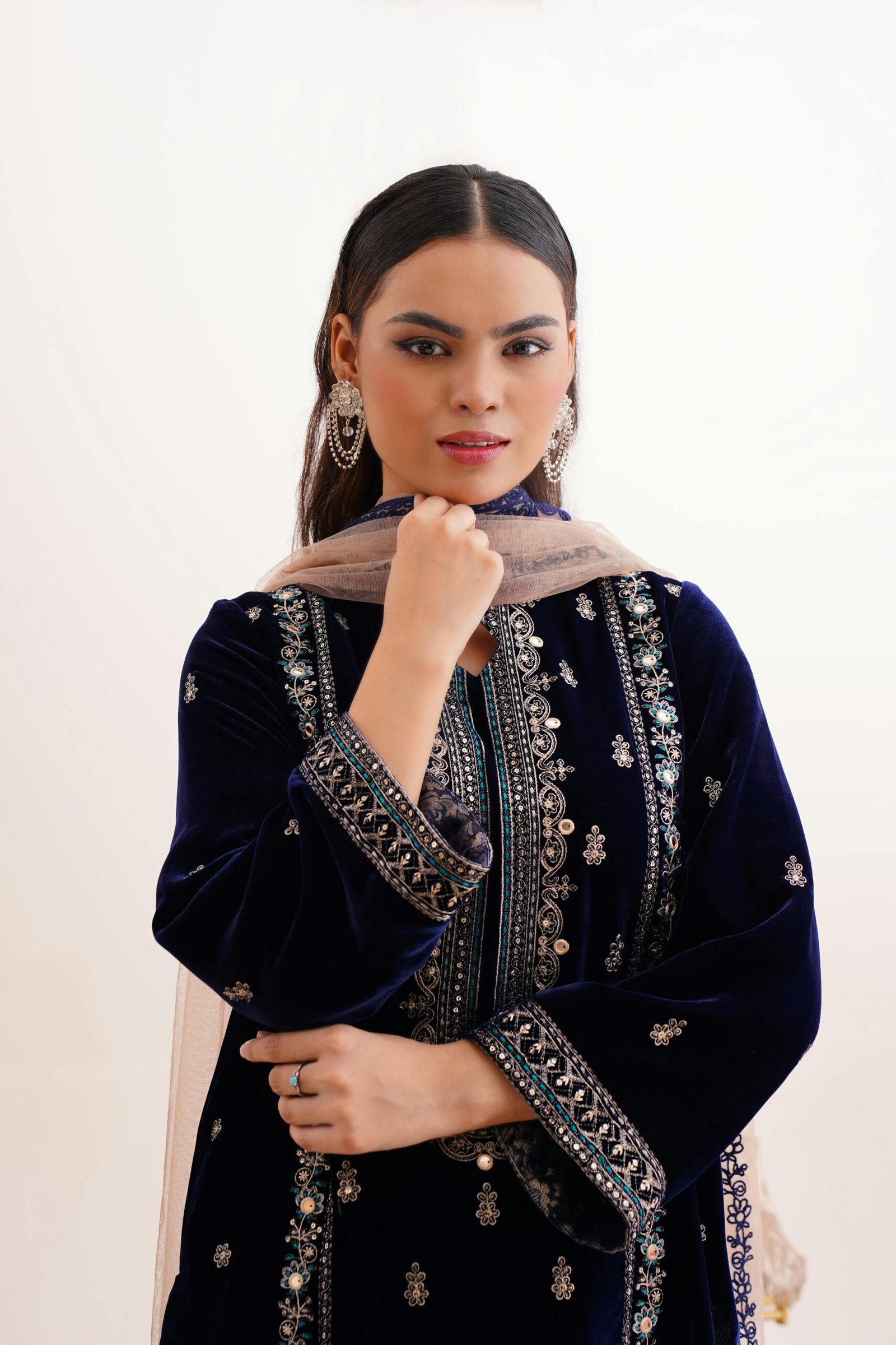 Home Elegant south asian woman wearing traditional embroidered dress in Lahore, Pakistan.
